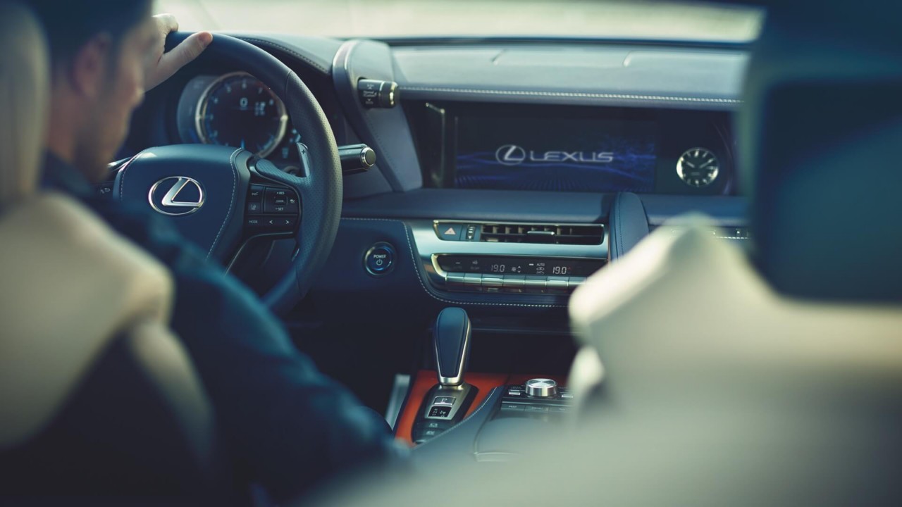 A person sat inside a Lexus