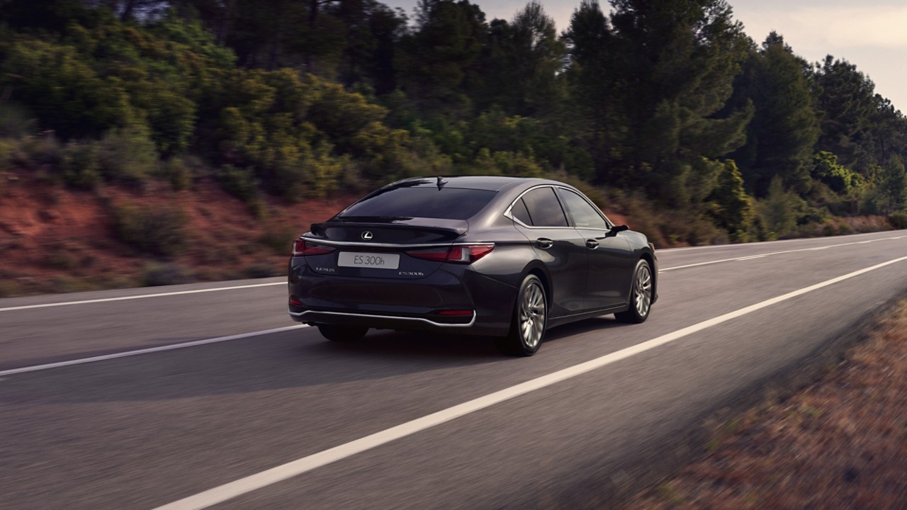 A black Lexus ES 300h driving on a road