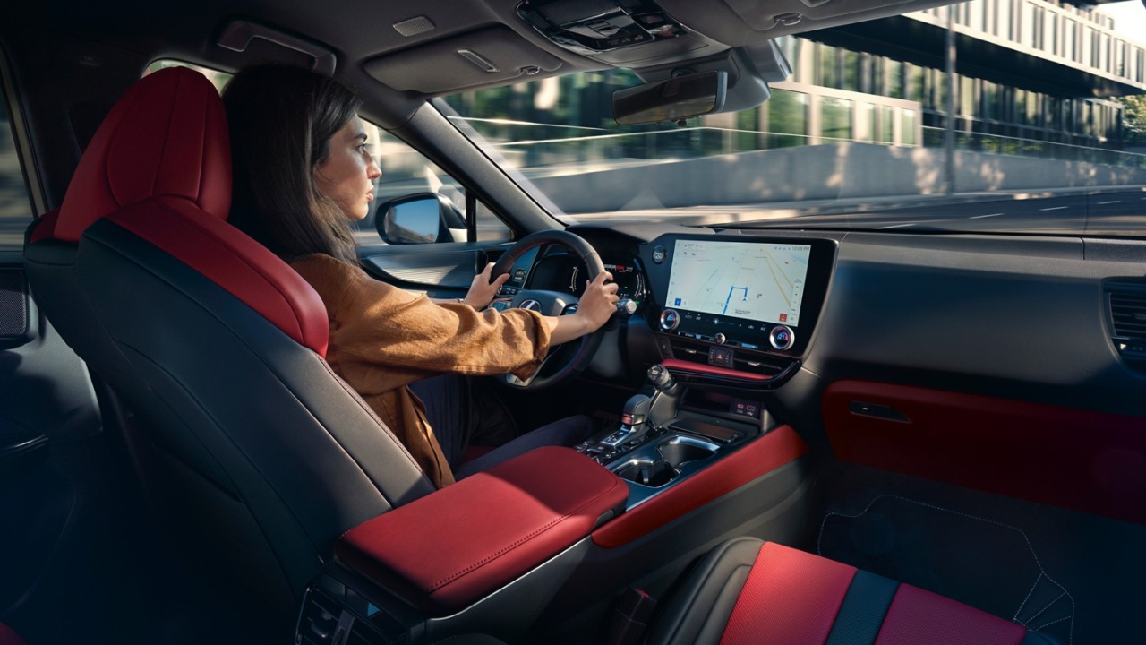 A woman driving a Lexus NX 