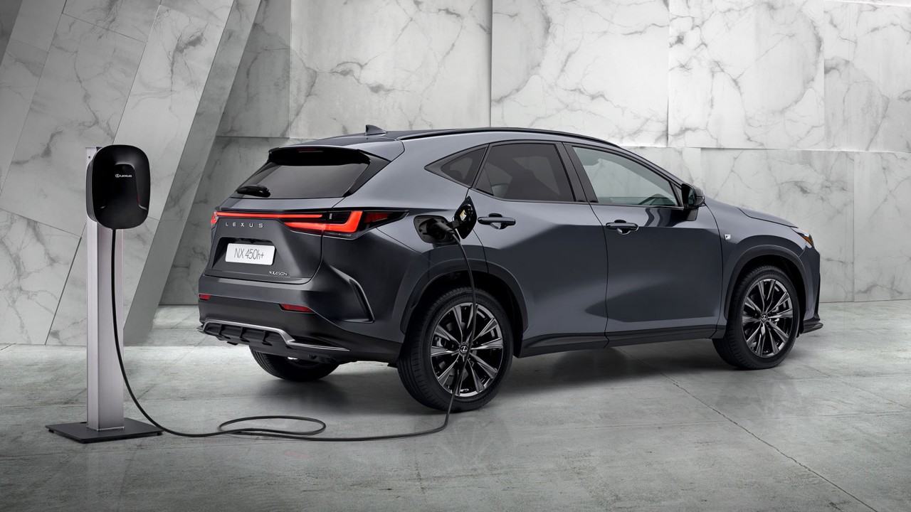 The Lexus NX 450h+ plugged into a charging tower